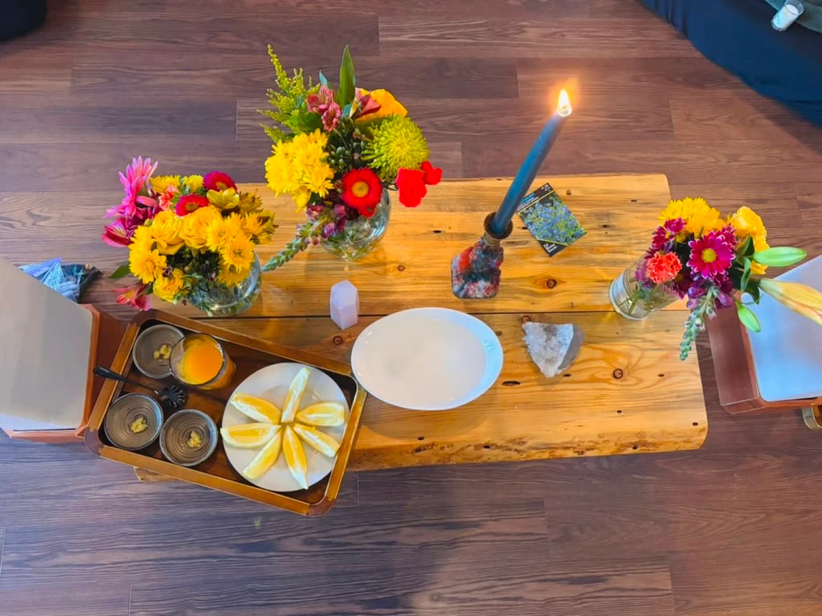The altar. Flowers, citrus, a single flame.
